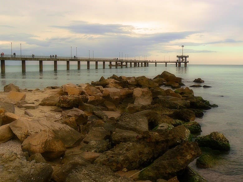 Burgas beach and its pier stretching into the Black Sea at sunset
