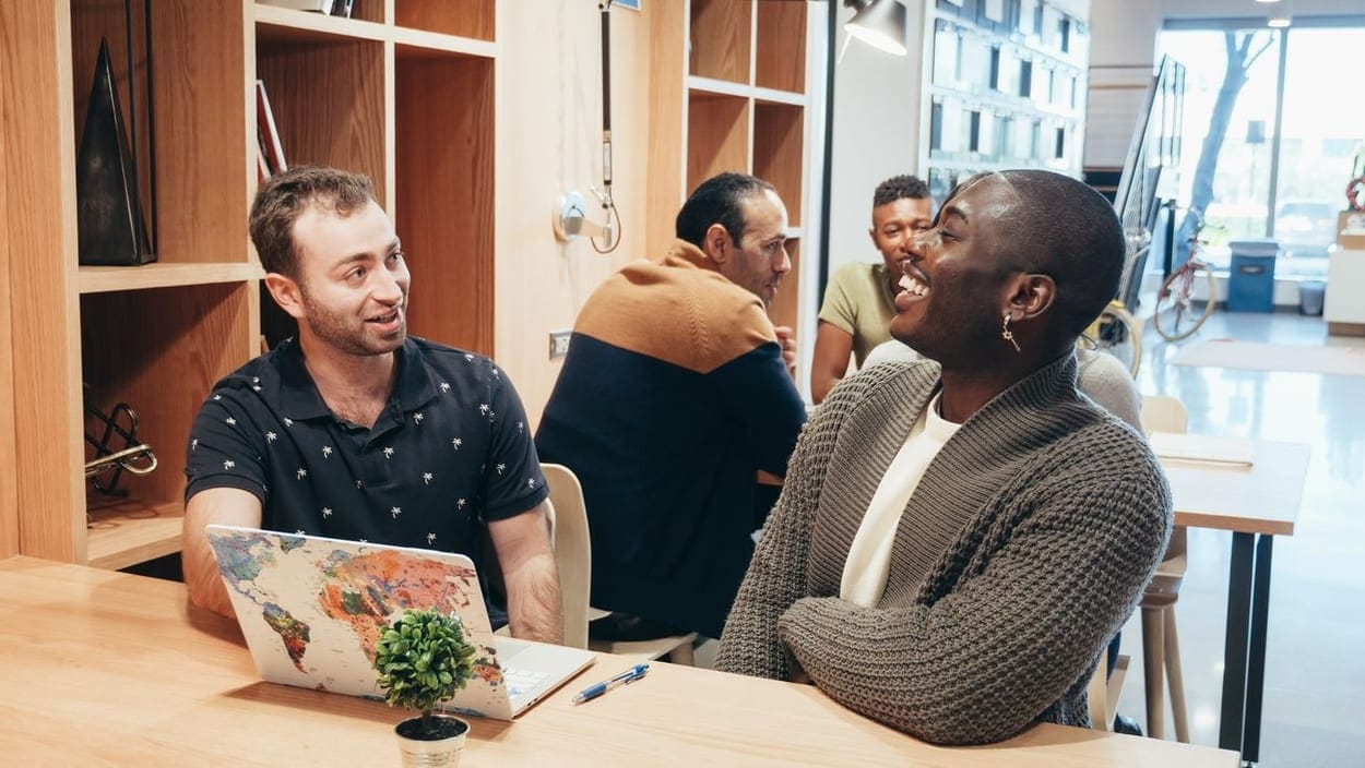 People working together in a bright coworking space (illustrative photograph)